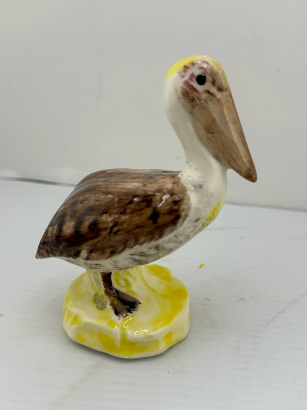 Vintage ceramic brown pelican figurine,